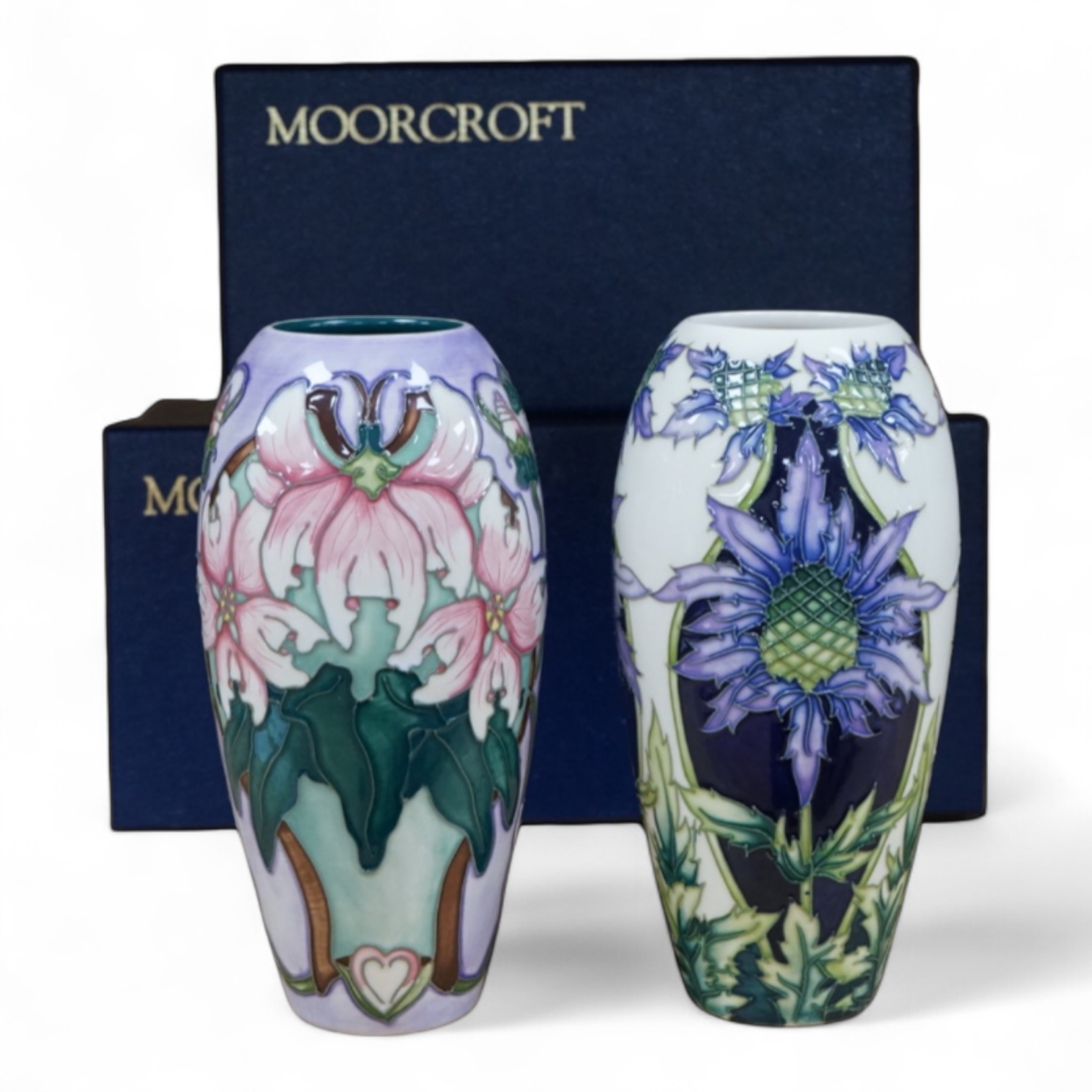 Two Moorcroft vases, Blakeney and a Caledonia patterns, both boxed, 18.5cm
